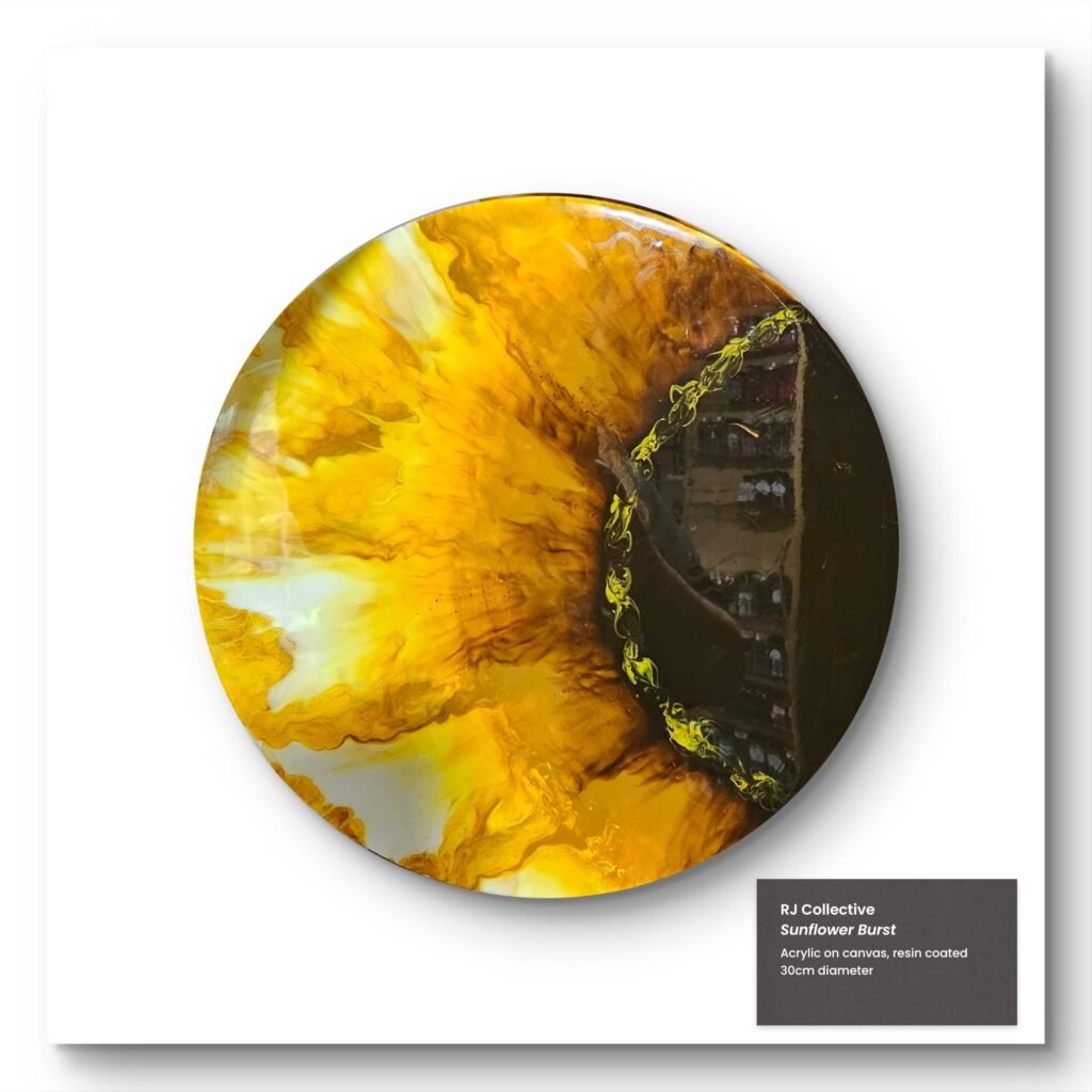 Circular acrylic pour painting by RJ Collective featuring vivid golden yellow petals radiating from a dark resin centre. "Sunflower Burst" captures sunlight, motion, and organic vibrancy.
