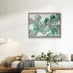 Abstract acrylic painting titled Blushing Ferns by Rebecca Jayne, featuring green and blush pink tones on canvas, framed in oak, set in a living room.