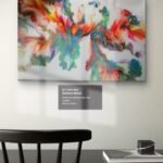 Large abstract acrylic painting by RJ Collective with vibrant flowing colours across a white base. "Rainbow Bloom" celebrates energy, diversity, and joyful movement in resin-coated form.